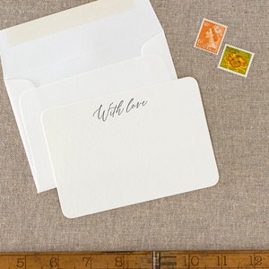 Small flat letterpress cards, printed with the text 'With love' at the top in a dark grey ink. Paired with matching ivory square flap envelopes.