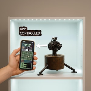 May include: A brown, metallic, app-controlled device with a cylindrical body and a small camera on top. The device is on a shelf, and a smartphone displays the control interface. The text "APP CONTROLLED" is above the device.