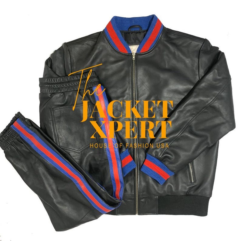 May include: Black leather jacket and matching pants set. The jacket has a blue and red striped collar and cuffs. The pants have a red and blue stripe down the side. The text "The Jacket Xpert House of Fashion USA" is visible.