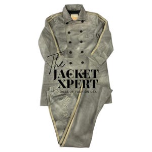 May include: A gray two-piece suit with a double-breasted jacket and matching pants. The jacket has black buttons and tan stripes down the sleeves. The pants have tan stripes down the sides. The text "The JACKET XPERT HOUSE OF FASHION USA" is visible.