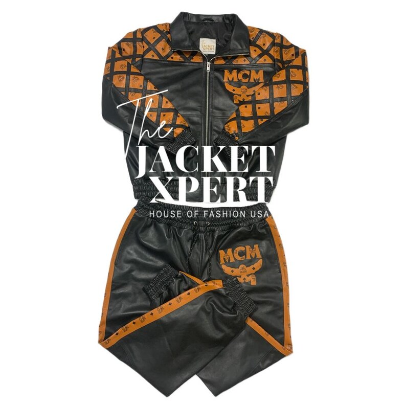 May include: Black leather jacket and matching pants set with brown diamond pattern accents. The jacket has a zip-up front and the pants have a drawstring waist. The set features the text "The Jacket Xpert" and "MCM" logos.