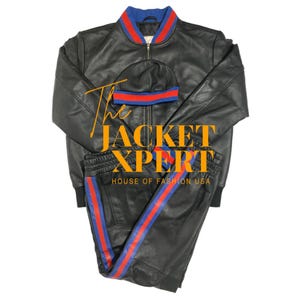 May include: Black leather jacket, beanie, and pants set. The jacket and beanie have blue and red striped accents. The pants have a blue and red stripe down the side. The text "The Jacket Xpert" and "House of Fashion USA" are visible.