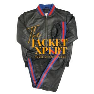 May include: Black leather jacket and matching pants set. The jacket has a blue and red striped collar and cuffs. The pants have a red and blue stripe down the side. The text "The Jacket Xpert" is visible.