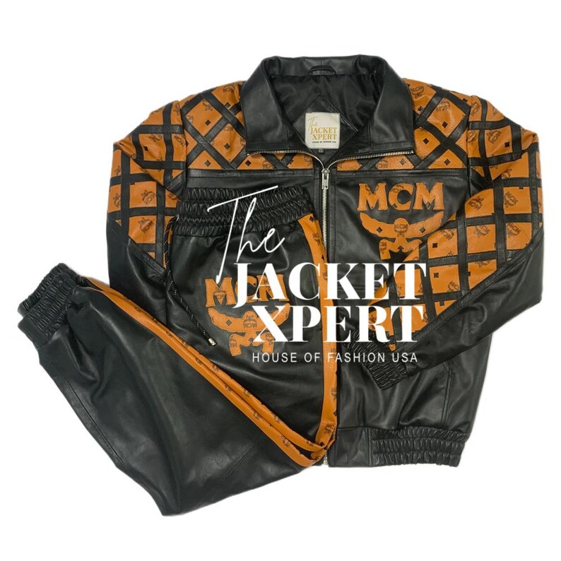 May include: Black leather jacket and matching pants set with a brown diamond pattern and the MCM logo. The jacket has a zipper closure and a collared neckline. The pants have a drawstring waist and a brown stripe down the side. The text "The Jacket Xpert" is visible.