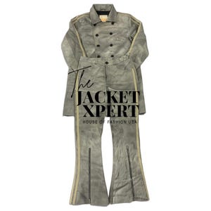 May include: A two-piece gray suede outfit featuring a double-breasted jacket and flared pants. The jacket and pants have a light beige stripe down the sides. The text "The JACKET XPERT HOUSE OF FASHION USA" is visible.