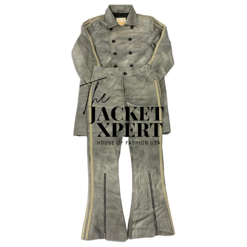 May include: A two-piece gray suede outfit featuring a double-breasted jacket and flared pants. The jacket and pants have a light beige stripe down the sides. The text "The JACKET XPERT HOUSE OF FASHION USA" is visible.