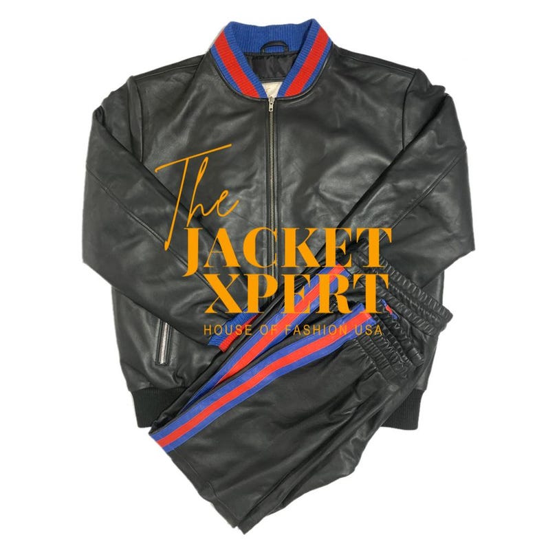 May include: Black leather jacket and matching pants set. The jacket has a blue and red striped collar and cuffs. The pants have a blue and red stripe down the side. The text "The JACKET XPERT HOUSE OF FASHION USA" is visible.