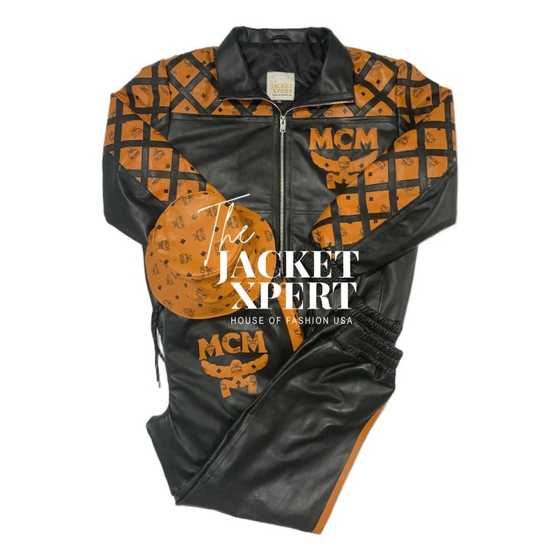 May include: A black leather jacket, pants, and hat set with brown diamond-patterned accents. The jacket and pants feature the MCM logo. The set includes a zip-up jacket, drawstring pants, and a matching hat. The text "The JACKET XPERT HOUSE OF FASHION USA" is visible.