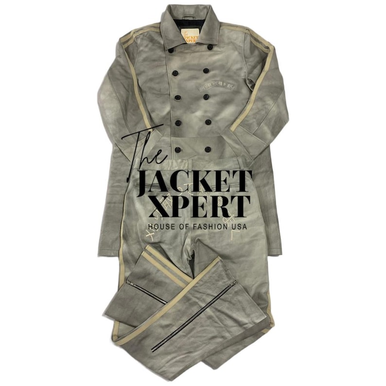 May include: A light gray two-piece suit with a double-breasted jacket and matching pants. The jacket has black buttons and tan stripes down the sleeves. The pants have tan stripes down the sides and zippers at the ankles. The text "The JACKET XPERT" is visible.