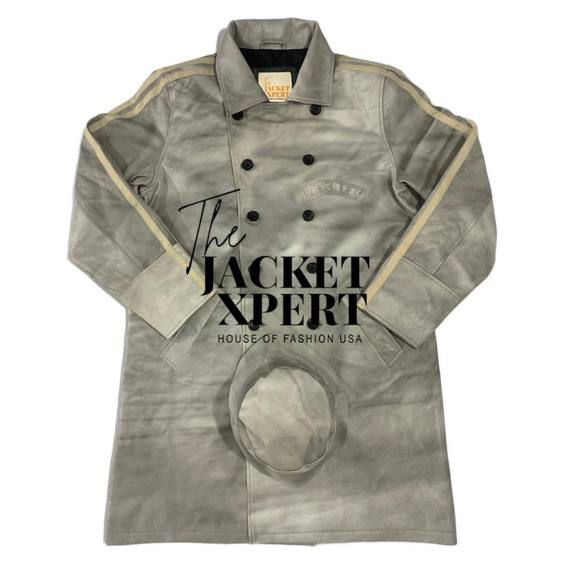 May include: A light gray suede jacket with a matching hat. The jacket has a double-breasted design with black buttons, cream-colored stripes on the sleeves, and the text "The JACKET XPERT HOUSE OF FASHION USA".