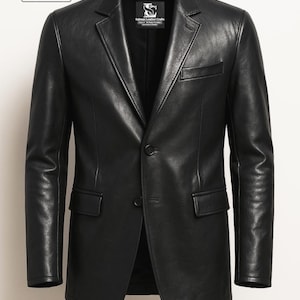May include: A black leather blazer with a two-button fastening, notched lapels, and two front pockets. The blazer has a classic design suitable for various occasions. The brand name "Salman Leather Crafts" is visible on the upper left.