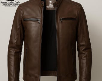 May include: A brown leather jacket featuring a stand-up collar and a front zip. It has two zipped chest pockets and two side pockets. The label displays the brand name "Salman Leather Crafts".