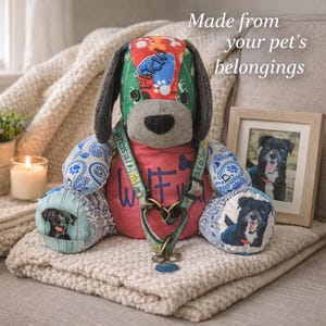 May include: A stuffed dog toy crafted from various fabric patterns, including a green head with the word FETCH, a red chest with the text WUF, and blue paisley limbs. A pet harness is draped around its neck, and it features photos of dogs.