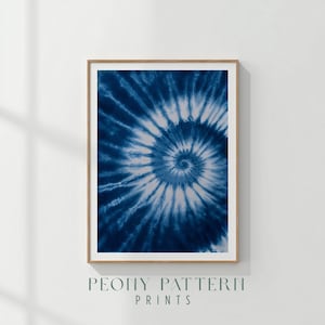 May include: Framed art print featuring a blue and white tie-dye spiral pattern. The artwork is displayed in a wooden frame and is labeled "PEONY PATTERN PRINTS" in a serif font.