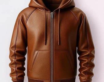 May include: A brown leather hooded jacket with a full-length zipper closure. The jacket features a front pocket, ribbed cuffs, and a ribbed hem. The jacket's hood has drawstrings. The jacket is a medium brown color.