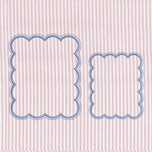 May include: Two blue scalloped-edge frames on a pink and white striped background. The frames are outlined with a darker blue stitching, and the background has a vertical stripe pattern.