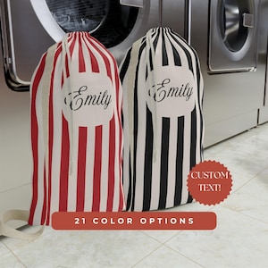May include: Two laundry bags with vertical stripes. One is red and white, the other is black and white. Each bag has a white circle with the name "Emily" in script. The image also includes text that says "Custom Text!" and "21 Color Options".