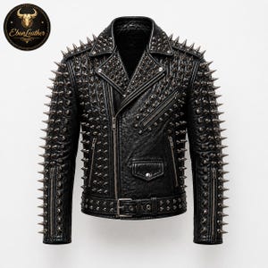 May include: Black leather jacket with silver metal spikes and zippers. The jacket has a classic biker style with a notched collar, asymmetrical zip closure, and a belt at the waist. The Ebon Leather logo is in the upper left corner.
