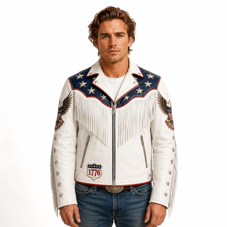 May include: A white leather motorcycle jacket featuring a blue yoke with silver star studs, long white fringe across the chest and sleeves, and eagle graphics on the shoulders. A shield-shaped patch with the text 1776 is on the lower front.