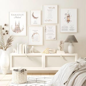 May include: A collection of framed art prints with a Ramadan theme. The prints feature floral designs, a crescent moon, a mosque, and the words "Ramadan Mubarak." The color palette includes white, beige, and soft pastel tones, creating a serene and elegant aesthetic.