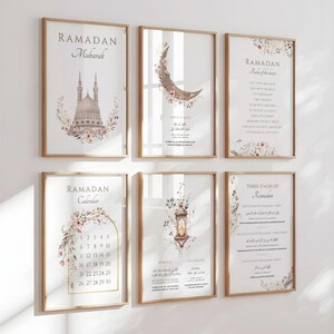 May include: Set of six framed art prints with a Ramadan theme. The prints feature calligraphy, floral accents, and imagery of a mosque, crescent moon, and lantern. The frames are a light wood color, and the prints are displayed on a white wall.