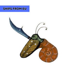 May include: A sticker featuring a whimsical illustration of a snail with a sword. The snail has a brown shell, a green head, and a blue sword. The sticker has a white border.