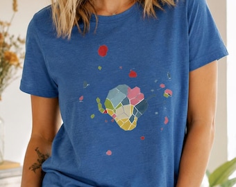 May include: A blue crew neck t-shirt with a colorful geometric design on the front. The design features a variety of shapes and colors, including pink, yellow, and blue. The shirt is made of a soft material and is suitable for casual wear.