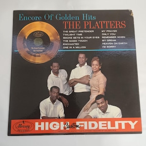 May include: Vintage vinyl record album cover for "Encore of Golden Hits" by The Platters. The cover features a gold record graphic and a photo of the group. The album includes songs like "The Great Pretender" and "My Prayer".