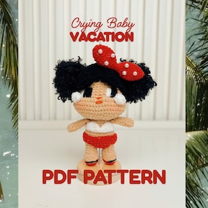 May include: A crocheted doll with black hair in two buns, wearing a red and white bikini and a red bow with white beads. The text Crying Baby VACATION and PDF PATTERN is visible. The doll has a tan complexion and stands on a circular base.