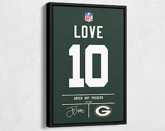 May include: Framed artwork of a Green Bay Packers jersey design. The jersey shows the name "LOVE" above the number "10" in white, on a green background. Includes the NFL logo and team details.