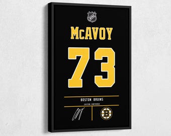 May include: Framed black wall art featuring the name "McAvoy" and the number "73" in yellow. The Boston Bruins logo and text are at the bottom. The NHL logo is at the top. A signature is below the text.
