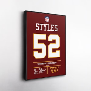 May include: A framed rectangular wall art print featuring a burgundy background with the NFL logo, the name STYLES, and the number 52 in white with yellow outlines. It includes the text WASHINGTON COMMANDERS, NFC EAST, and a signature graphic.