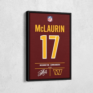 May include: Framed artwork with a burgundy jersey design. It displays the name "McLAURIN" and the number "17" in gold. The Washington Commanders logo and signature are at the bottom. The NFL logo is at the top.
