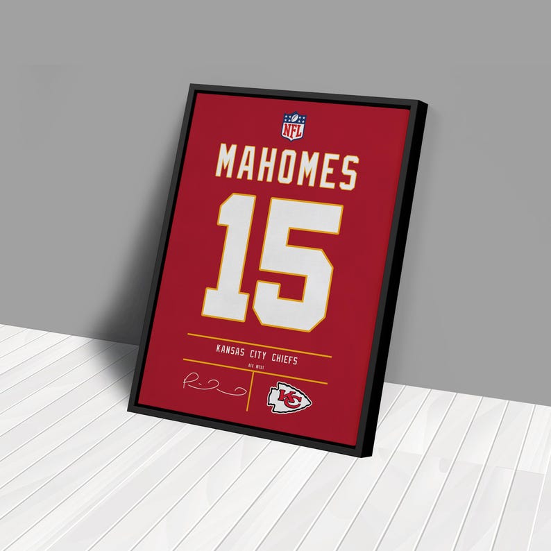 May include: Framed red Kansas City Chiefs jersey art featuring "MAHOMES" and the number "15" in white. The NFL logo is at the top, with "KANSAS CITY CHIEFS" and a signature at the bottom. The frame is black.
