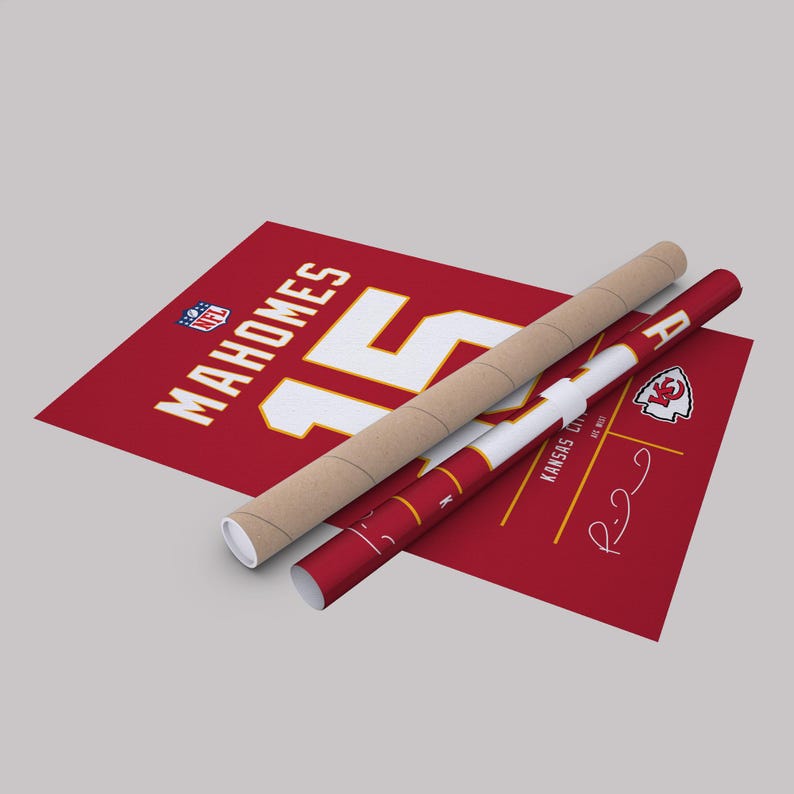 May include: A red poster featuring the name "Mahomes" and the number "15" in white. A rolled-up poster and a poster tube are also visible. The Kansas City Chiefs logo is displayed on the rolled poster.