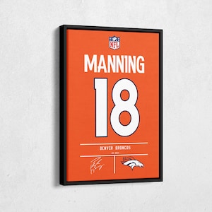 May include: Framed orange canvas art featuring the name "MANNING" and the number "18" in white. The NFL logo is at the top, with "DENVER BRONCOS" and a team logo at the bottom. A signature is also present.