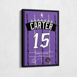 May include: Framed purple Toronto Raptors jersey featuring the name "CARTER" above the number "15" in white. The NBA logo is at the top, with the Raptors logo and signature at the bottom. The jersey is framed in a black border.