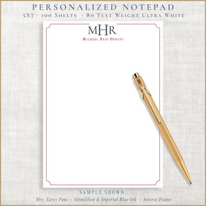 May include: A personalized notepad with a vermillion border and the initials "MHR" in navy blue. The notepad is 5x7 inches and includes 100 ultra-white sheets. A gold pen rests on the notepad.