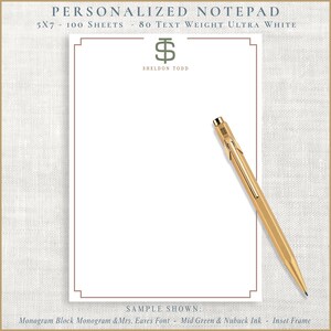 May include: A personalized notepad with a monogram and the text "SHELDON TODD". The notepad is 5x7 inches and has 100 sheets of ultra white paper. A gold pen rests on the notepad.
