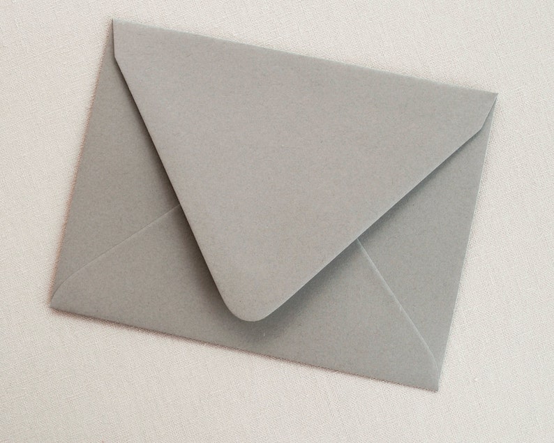 May include: A gray envelope with a pointed flap.