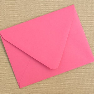 May include: A pink envelope on a beige textured background.