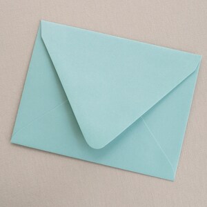 May include: A light blue envelope with a white flap.
