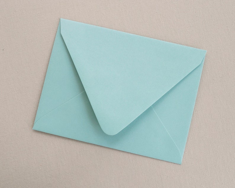 May include: A light blue envelope with a white flap.