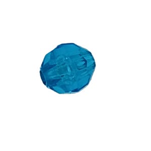 May include: A faceted, teal-colored bead. The bead has a rounded shape with multiple flat surfaces, creating a sparkling effect. The bead is isolated against a white background, highlighting its color and form. Ideal for jewelry making.