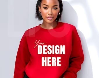 May include: A red sweatshirt with the text "Your DESIGN HERE" in white. The sweatshirt is a solid color and has a crew neck. The image shows a person wearing the sweatshirt.