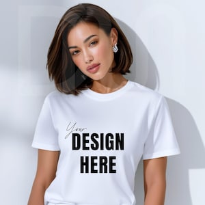 May include: White crew neck t-shirt with the text "Your DESIGN HERE" in black. The shirt is short-sleeved and appears to be made of a soft material. The design is centered on the front of the shirt.