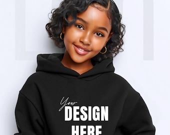 May include: A young person wearing a black hoodie with the text "Your Design Here" in white. The hoodie has a hood and is made of a soft material. The person is smiling and wearing gold hoop earrings.
