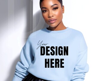 May include: A light blue sweatshirt with the text "Your DESIGN HERE" in black. The sweatshirt is worn by a person. The person is wearing a black skirt. The background is white.