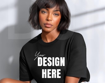 May include: Black t-shirt with the text "Your DESIGN HERE" in white, featuring a round neck and short sleeves. The shirt is worn by a person with short dark hair.