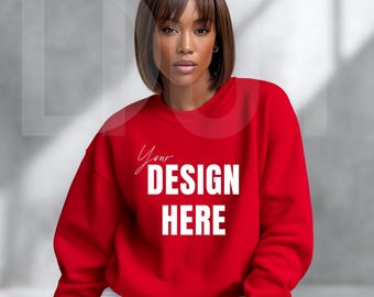 May include: A red sweatshirt with the text "Your DESIGN HERE" in white. The sweatshirt is a solid color and has a crew neck. The model is wearing white pants.